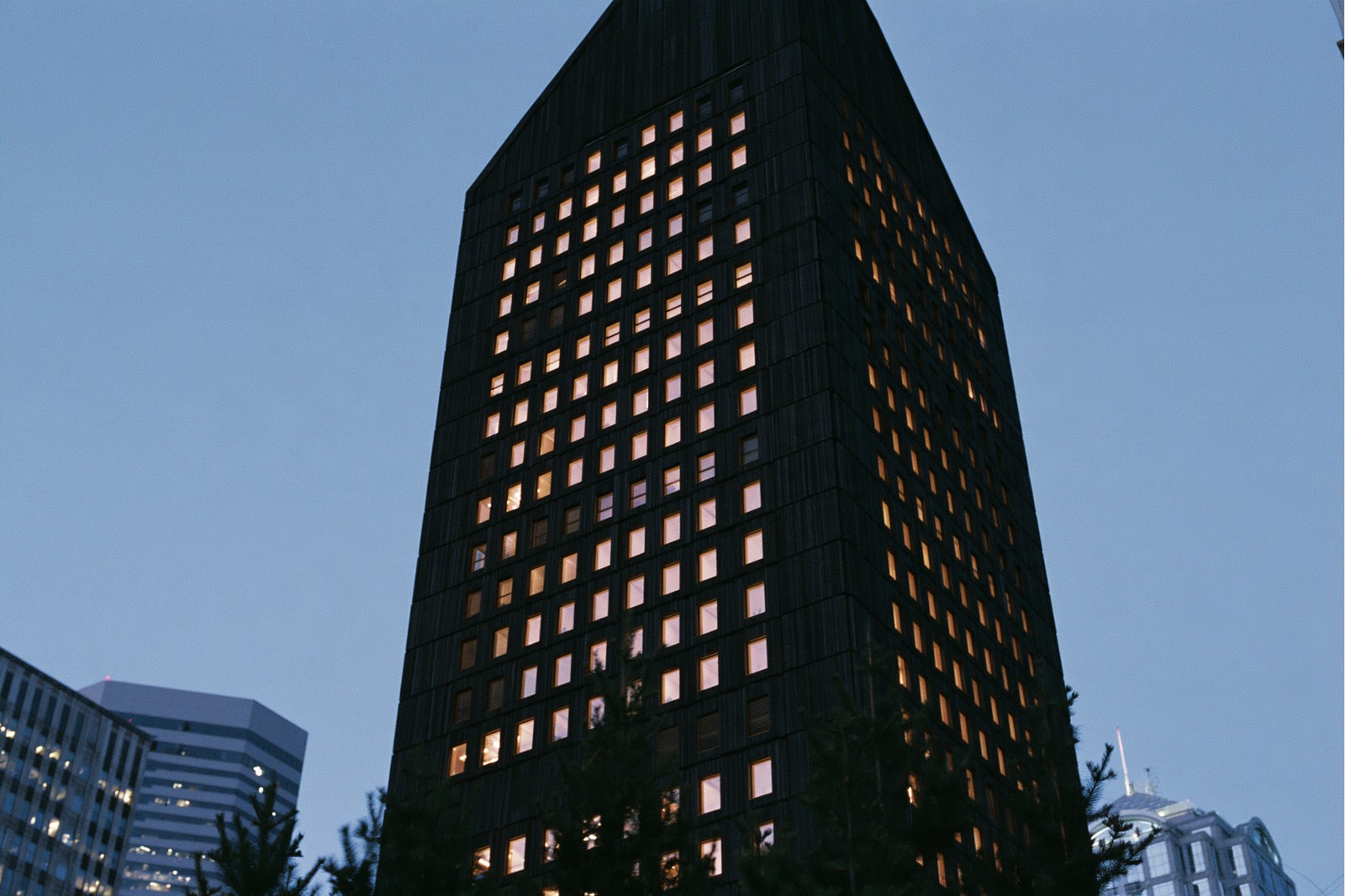 Nordic Timber high rise — Stacked charred-timber modules with a gable crown